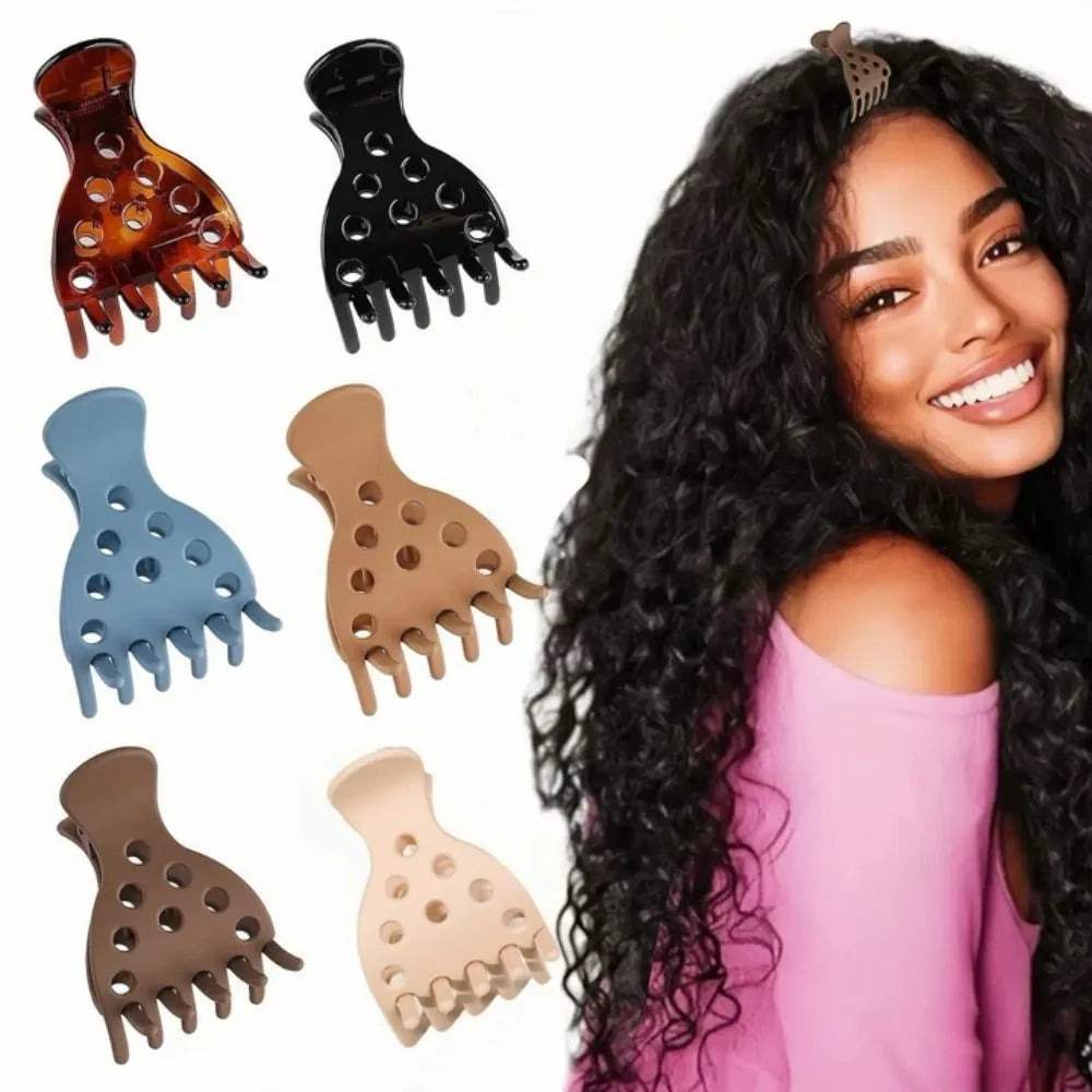 A collection of various hair clips used for root lifting, including black and brown plastic clips.
