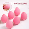 Six pink beauty egg puffs for cosmetics shown on a white surface.