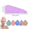 A pink microfiber hair towel wrap shown next to various colored fabric wraps.