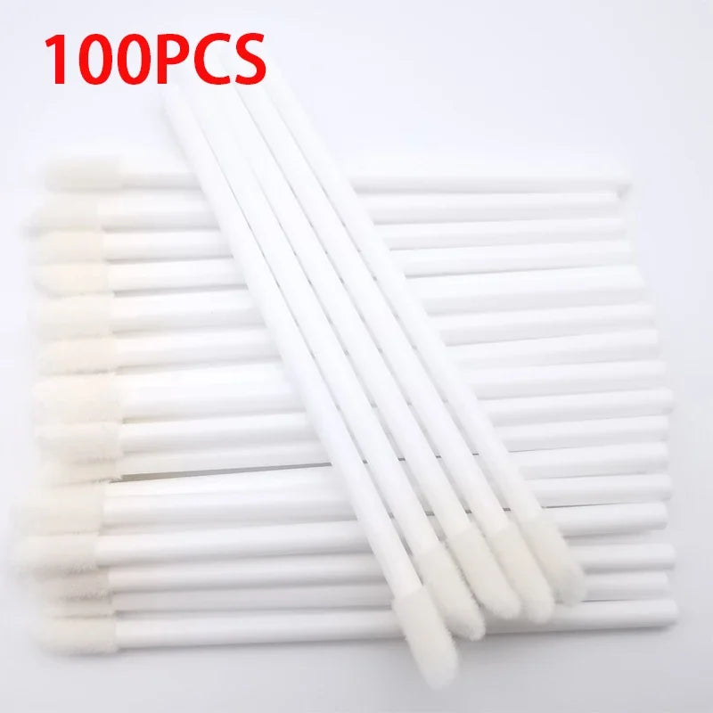A set of 100 white precision makeup brushes laid out in a row.