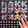 A collection of 3D floral butterfly pearl nail art charms in various colors and shapes.