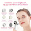 A woman is shown using a six-in-one cleansing brush with six heads on her face for facial cleaning.