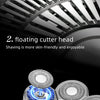 Close-up view of a silver electric shaver head with multiple rotating cutting discs.