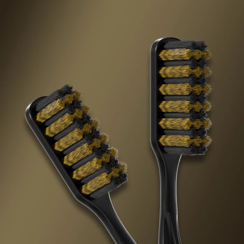 A black toothbrush with yellow and black bristles is shown against a brown background.