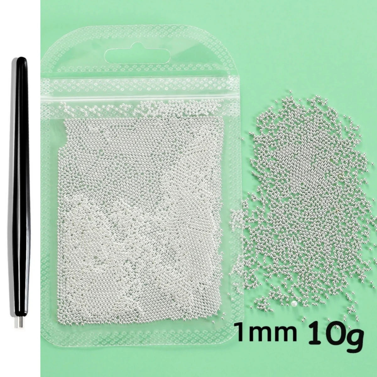 A clear plastic bag containing 10 grams of white 1mm stainless steel beads for nail art decorations.