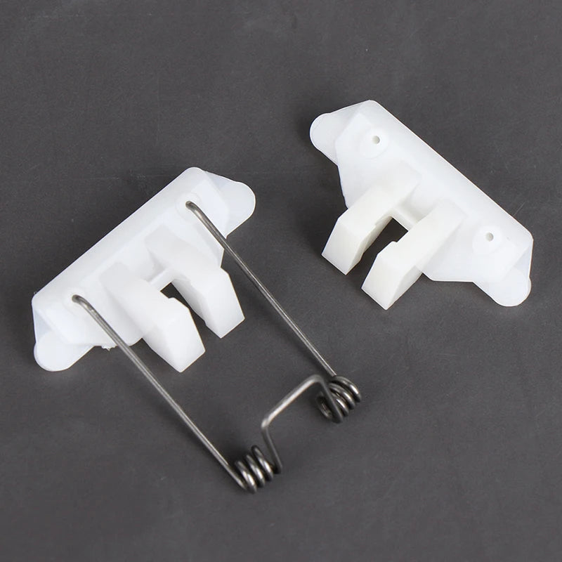 A white hair clipper swing head replacement parts kit showing a plastic housing and a metal spring.