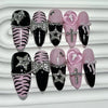 A set of glitter diamond press on nails featuring black, pink, and zebra print designs.
