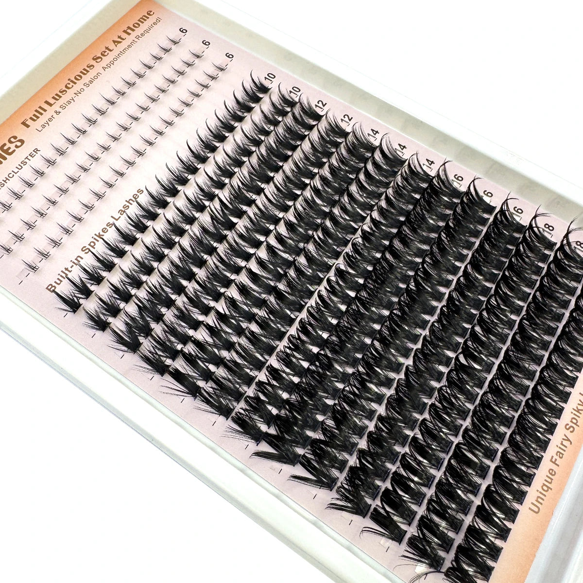 Exposition de clusters de cils pointus DIY pour extensions de salon, montrant divers styles et longueurs.