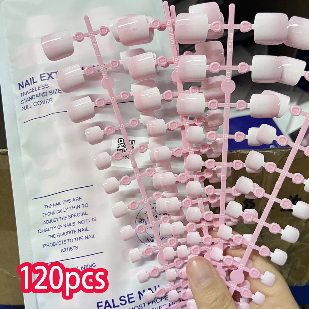 A collection of pink press-on nails for toenails displayed on a white background.