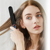 A woman holds a black professional negative ion hair straightener and curling iron near her hair.