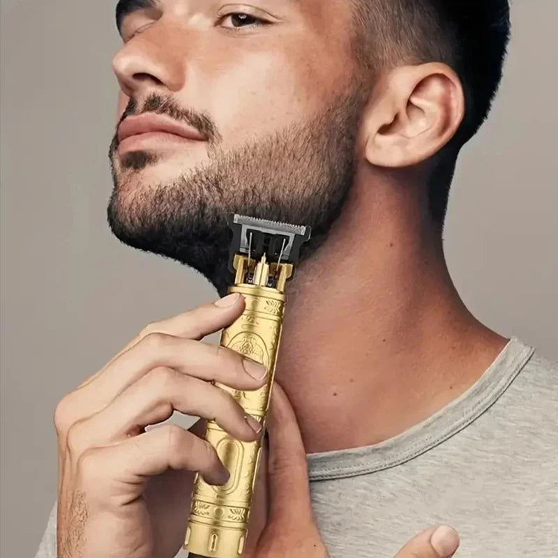 A man is holding a vintage gold-colored rechargeable hair clipper trimmer against his neck.
