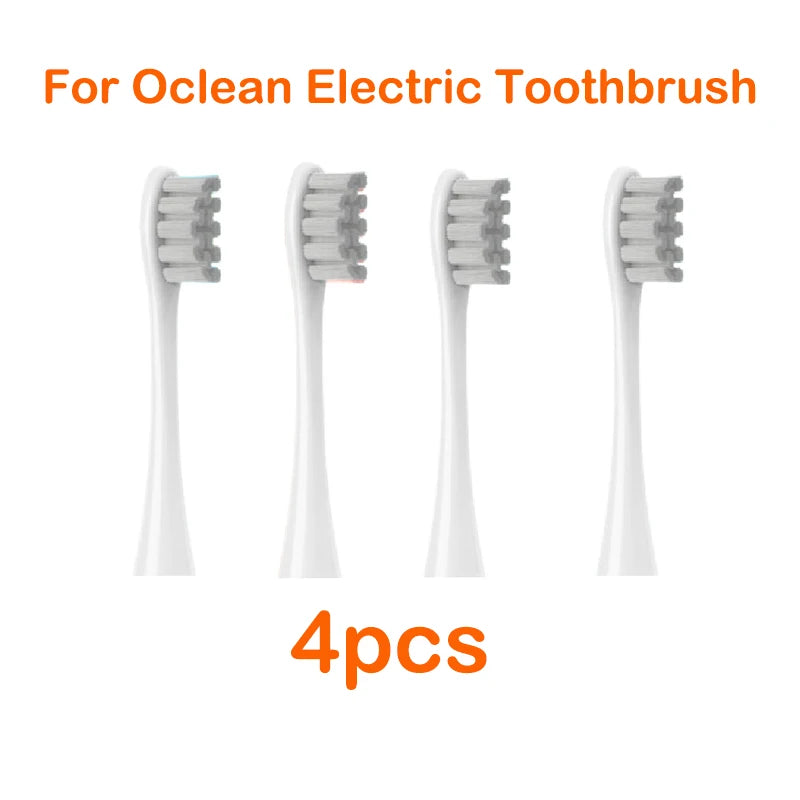Four white replacement brush heads for an Ocean electric toothbrush are displayed.