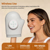 A woman is using a white electric hand massager, demonstrating its wireless use and features.