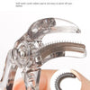 A close-up of a clear plastic eyelash curler tool with a rubber strip component shown on a finger.