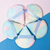 A set of five triangular cosmetic powder puffs in pastel pink and light blue hues tied with light blue ribbon.
