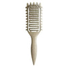 A beige professional curl define styling brush with a textured comb and tapered handle.