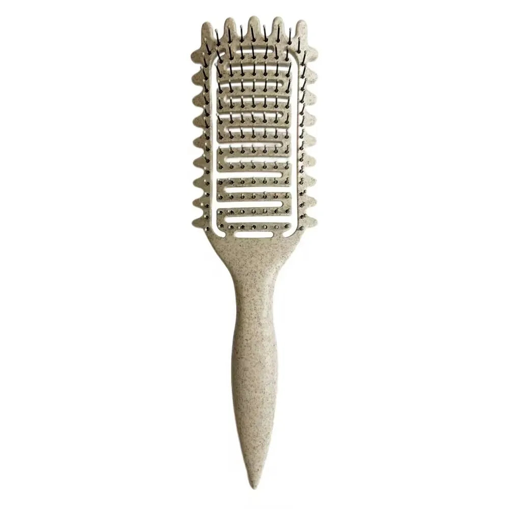 A beige professional curl define styling brush with a textured comb and tapered handle.