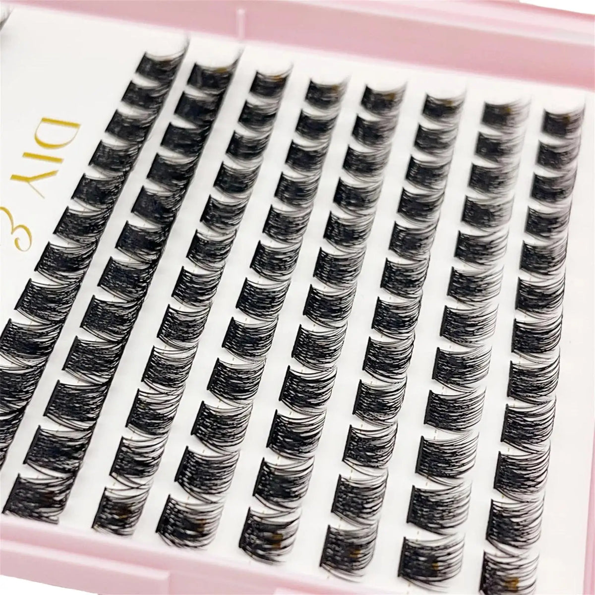 A tray of black bulk cluster eyelash extensions for DIY makeup application.