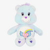 A light blue classic care bears plush stuffed animal doll with a rainbow design on its chest.