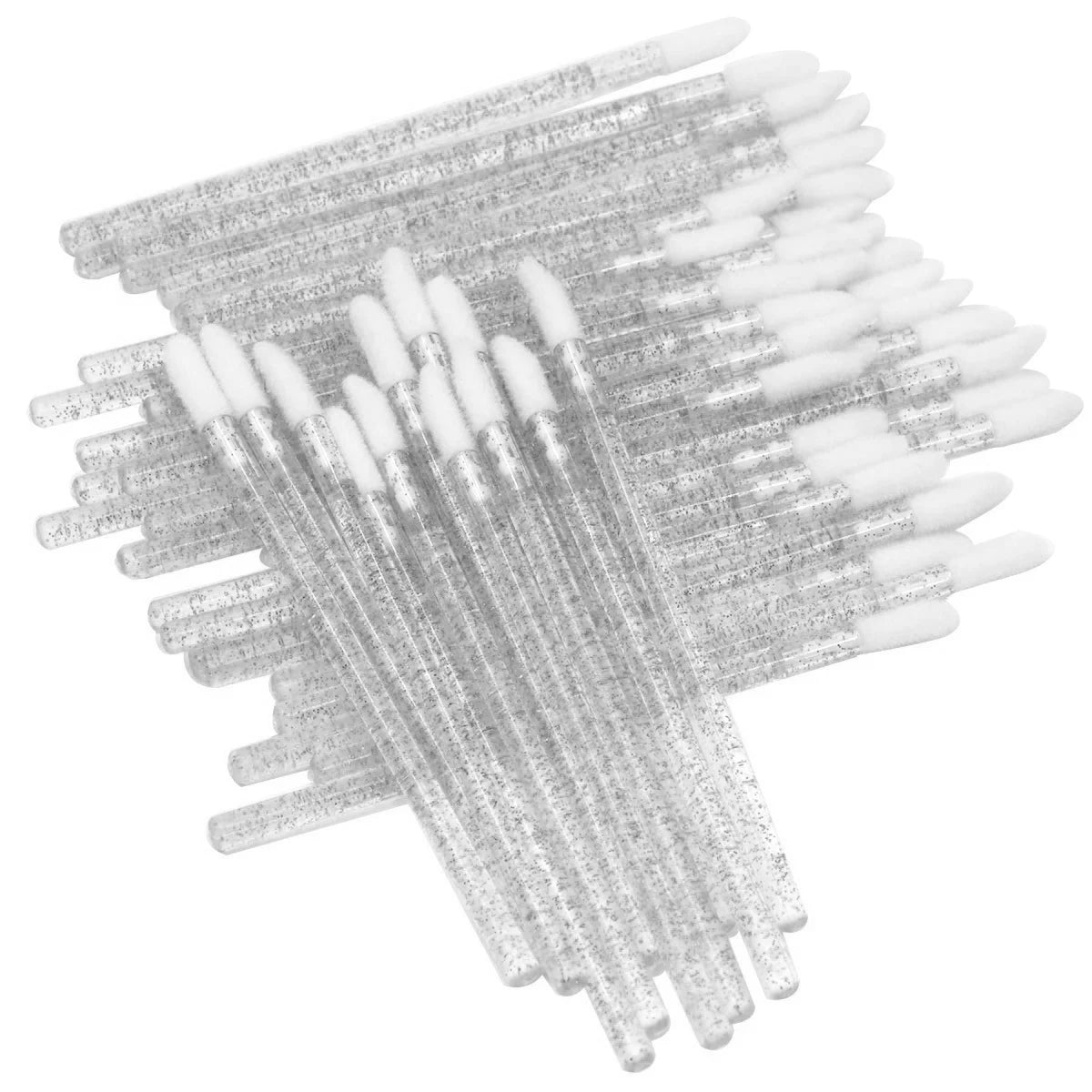 A collection of clear and white crystal lip brushes and lash spoolies arranged in a fan shape.