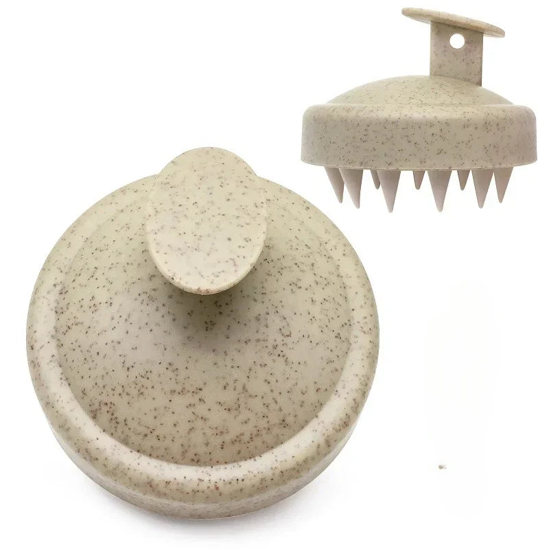 A beige silicone scalp massage and body brush with a flat head and multiple prongs.