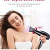 A woman is using a black hair dryer with a 360 degree swivel nozzle to style her hair.