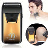 A close-up of a gold and black electric double-blade hair shaver showing 99% power left on a device.