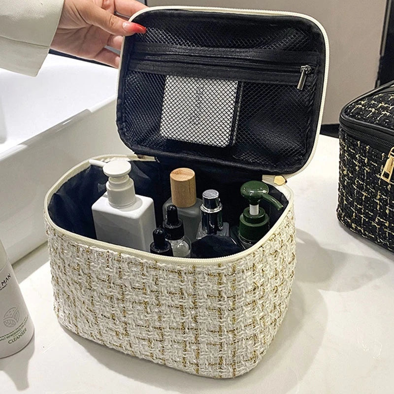 A beige knitted canvas makeup pouch is open, revealing various cosmetic bottles and a mesh accessory.