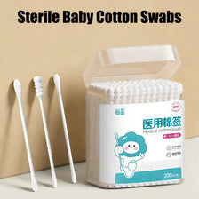 A clear container of sterile baby cotton swabs with several white swabs displayed next to the packaging.