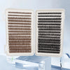 A pair of clear plastic lash trays filled with dark brown and black faux mink cluster lashes.