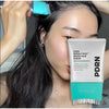 A bottle of PDRN Reedle Shot Brush Hair Serum is shown next to a person's face, demonstrating its use for scalp care.