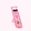 A pink portable mini eyelash curler set with a metal coil visible.