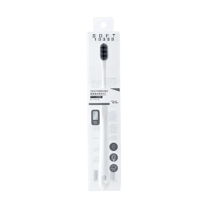 A white soft bristled toothbrush is shown in its packaging box.