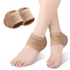 Tan silicone heel protectors shown on a foot, with extra protectors nearby.