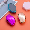 A pink and gold glass foot file tool is shown next to a metallic blue storage case on an orange background.