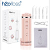 A pink portable water flosser device and its accessories are shown in a box and individually.