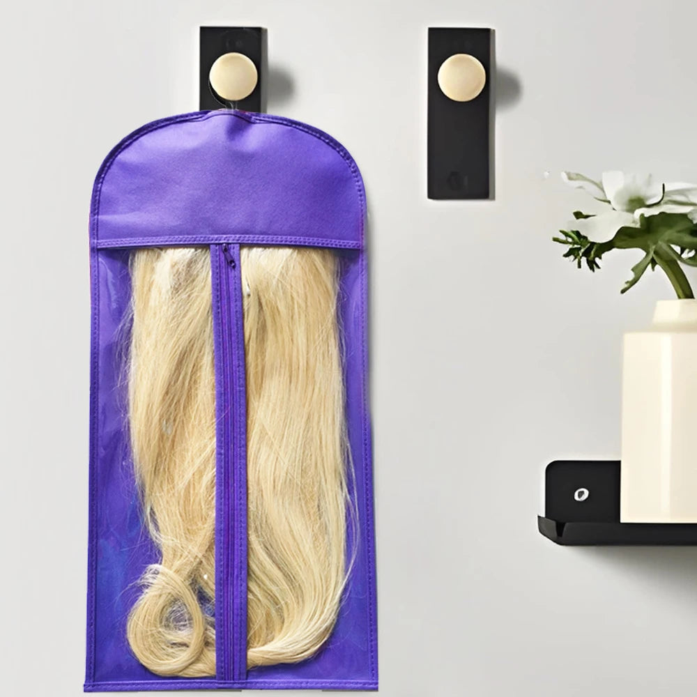 A purple storage bag for a blonde wig with a metal hanger, mounted on a gray wall.