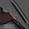 A close-up of a black hair straightener applying heat to dark brown hair, showing steam and glossy finish.