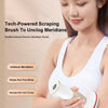 A woman is using a white electric meridian brush for body massage and toning.