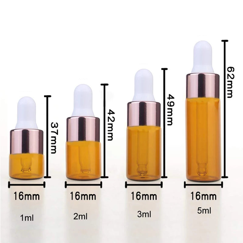 A set of five glass dropper bottles containing essential oils or samples, showing various volumes from 1ml to 5ml.