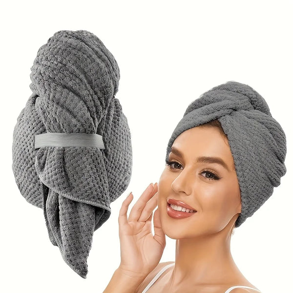 A woman is shown wearing a gray microfiber hair towel wrap on her head.