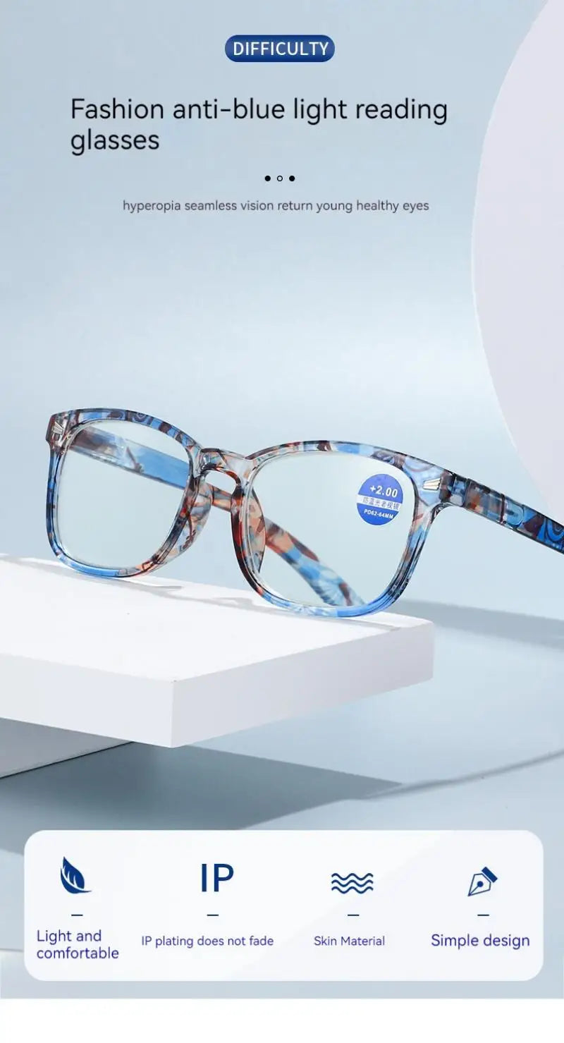 Pair of blue-tinted reading glasses with a marbled frame resting on a white surface.