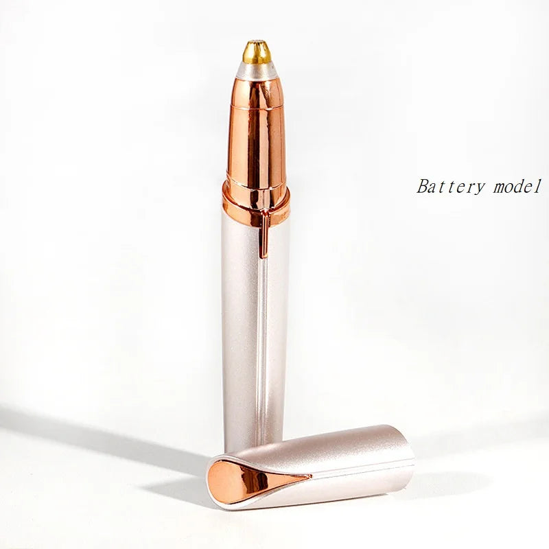 A silver electric eyebrow trimmer and epilator with a gold tip shown against a white background.
