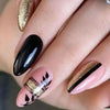 Close-up of a hand displaying press-on false nails with a French wavy design featuring black and gold accents.