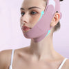 A woman is wearing a pink facial lifting strap built in graphene material on her face.