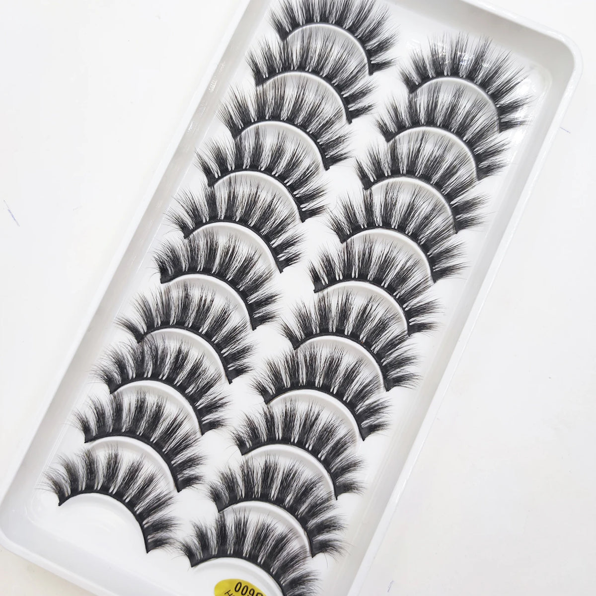 A tray of natural 3D mink false eyelashes displayed for sale.
