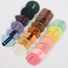 A set of nine air cushion beauty puffs in various earthy and pastel shades arranged diagonally.