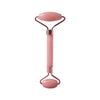 A pink resin facial massage roller set with a handle and two rollers.