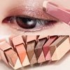 A close-up of a pink eyeshadow stick and applied shimmer on an eye.