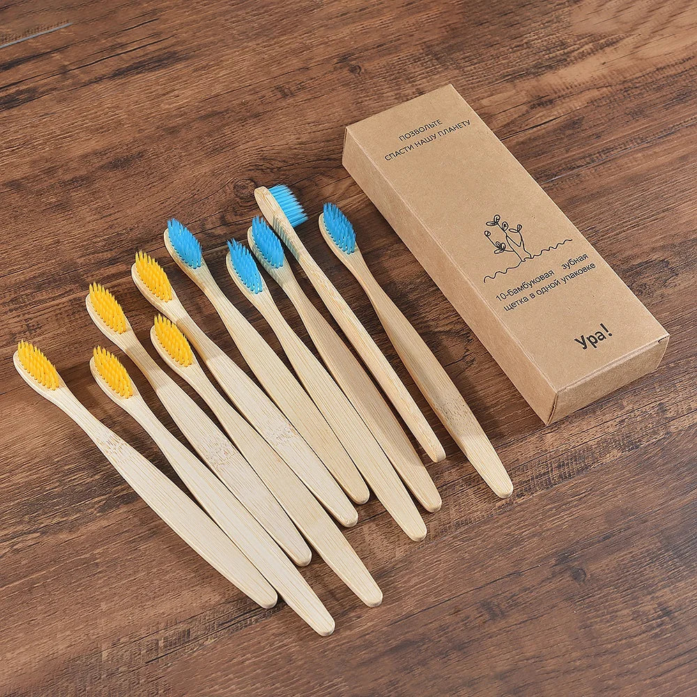 A box containing a set of ten natural bamboo toothbrushes is displayed on a wooden surface.